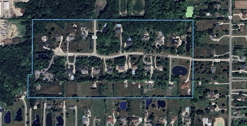 An aerial photograph of Countryside Reserve (also spelled Country Side Reserve), a community of 21 custom-built luxury homes in Hinckley, Ohio 44233. The subdivision is designated with a blue border around its perimeter, comprising Country Brook Drive (aka Township Rd 549). The neighborhood features a cul-de-sac street and lots with varied landscape including lightly treed to partially wooded homesites.
