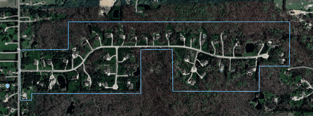 An illustrated map of The Estates at Stone Ridge, a community of roughly 40 custom-built single-family luxury homes in south-central Hinckley, Ohio 44233, located off the east side of Stony Hill Rd.  The subdivision is designated with a blue border around its perimeter, comprising the streets of Autumn Brook Trail, Pine Ridge Trail, and Stone Ridge Dr. Lots are primarily rectangular in shape and sized around 2 acres. These homes were built between 2001-2021 and range from 3,800-9,000+ square feet.
