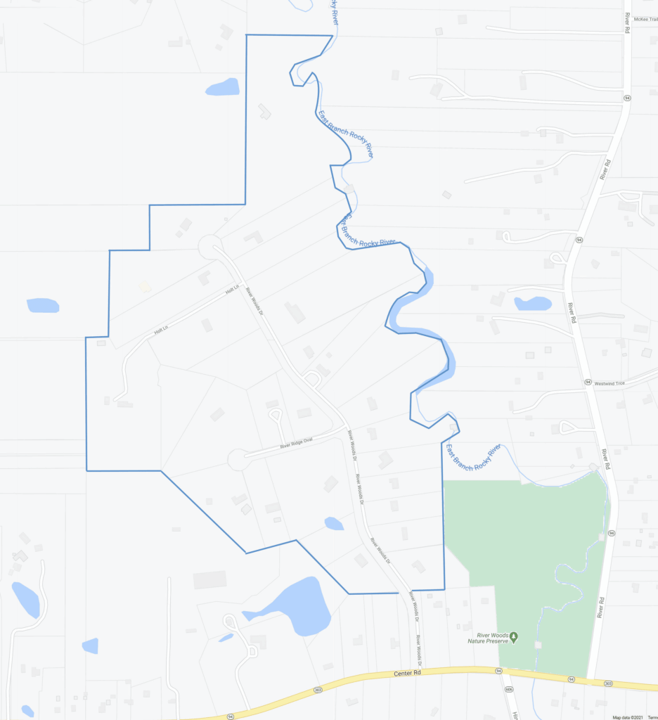 An illustrated map of River Woods Estates, an esteemed subdivision of roughly 26 custom-built single-family luxury homes located off the north side of Center Rd in Hinckley, Ohio 44233. The perimeter of the subdivision is lined with a blue border, comprising the cul-de-sac streets of River Woods Dr and River Ridge Oval, and the private drive of Holt Ln. The East Branch Rocky River meanders along the east end of the development. Several homes along the southeast end of River Woods Dr abut the 30-acre River Woods Nature Preserve. The average lot size in this community is approximately 4 acres. These one-of-a-kind homes were built between 1990-2022 and range from 4,500-9,800 square feet with 4-8 bedrooms and 3.5-6.5 bathrooms.