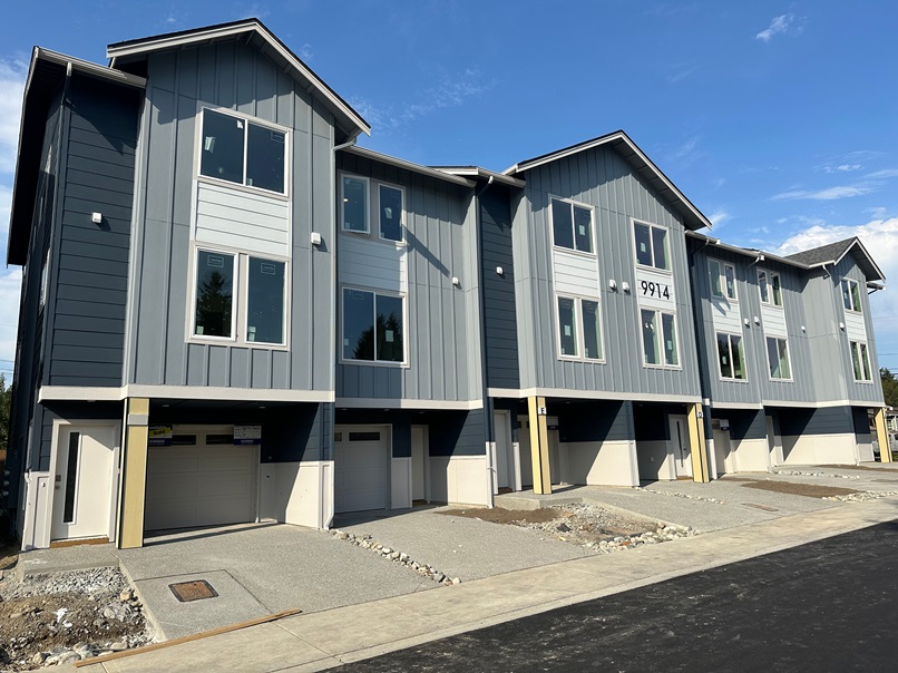 New construction townhouse in Everett, WA with modern gray siding, large windows, and a two-car garage
