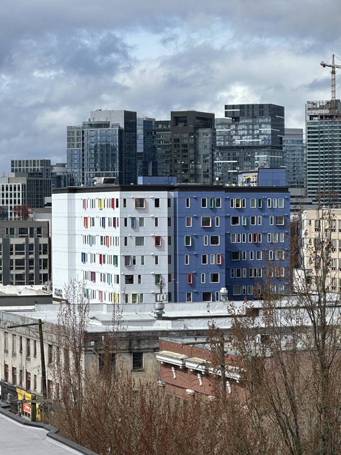 Rooftop view of colorful modern condos in Seattle’s Capitol Hill neighborhood under a clear sky. Capitol Hill Condo Building