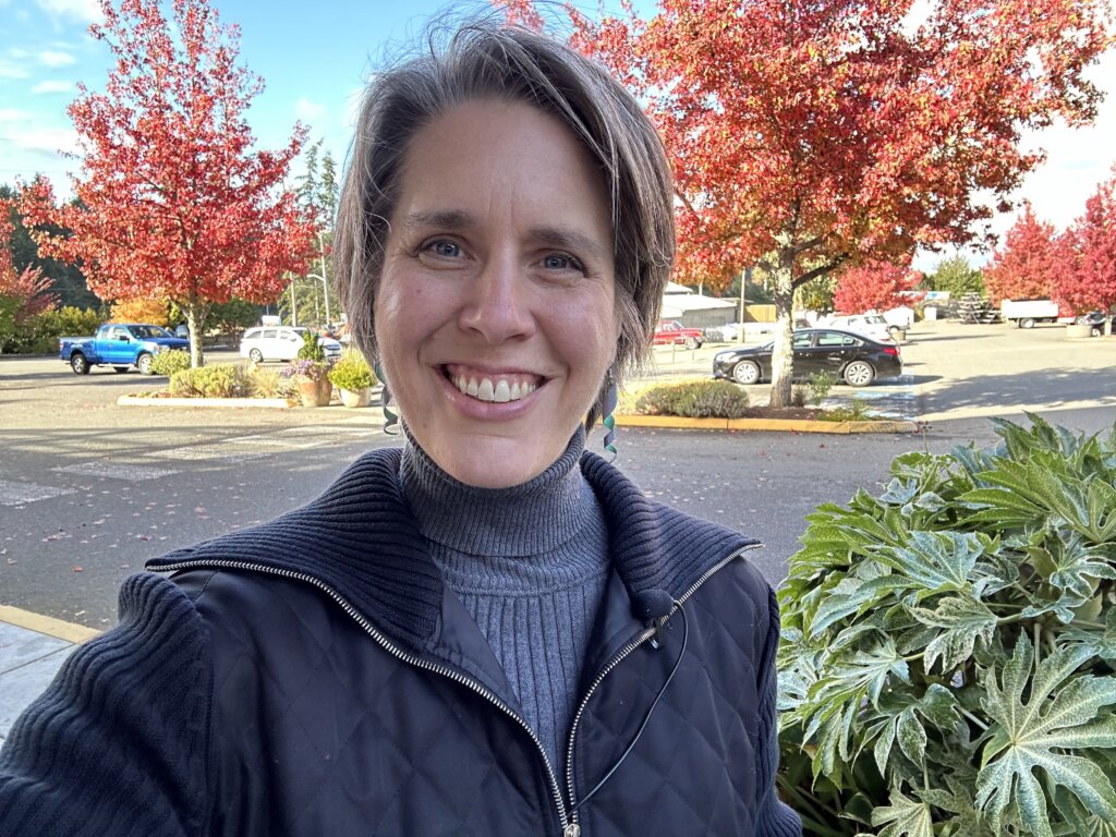 Emily Cressey smiling outdoors in autumn in the Seattle area
