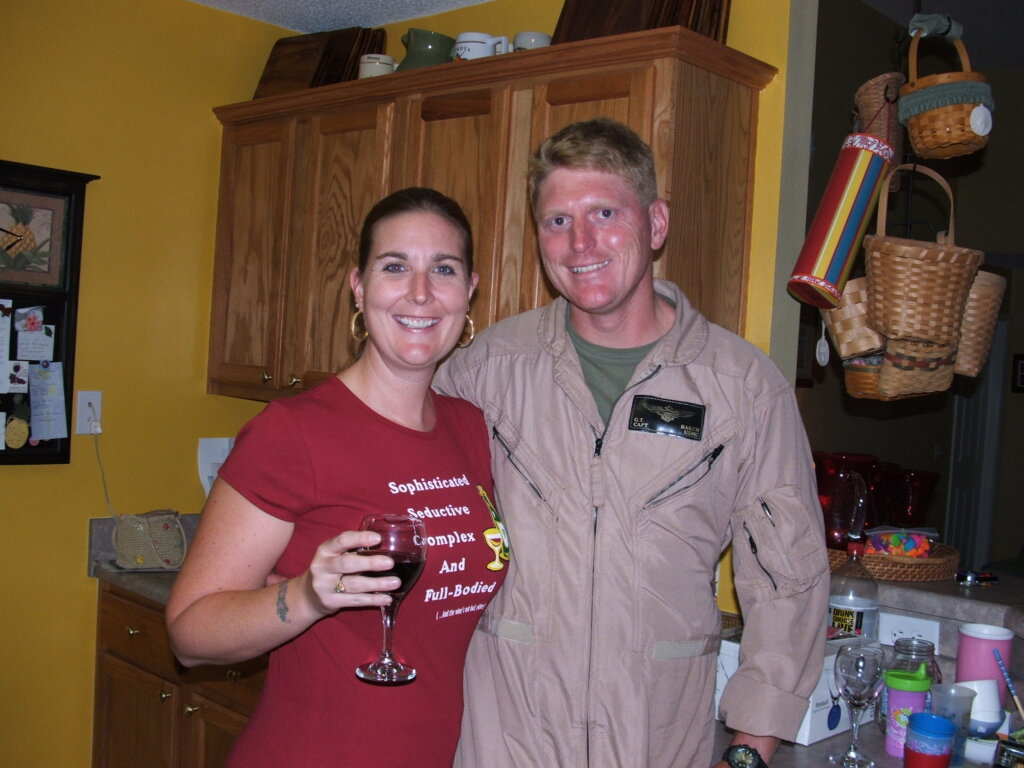 Photograph of Greg in military jumpsuit with his wife