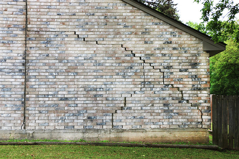 House with foundation problems and cracks in the brick