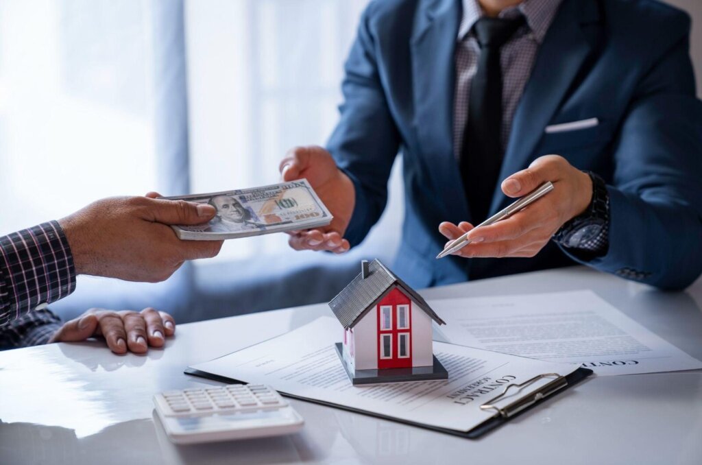 Homeowner reviewing mortgage paperwork and a cash offer for a Greensboro house