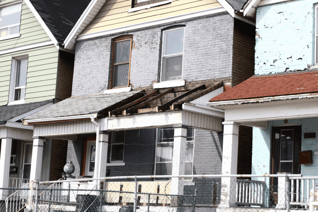 Old house with damaged porch and peeling paint
