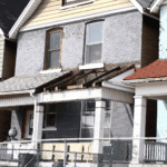 Old house with damaged porch and peeling paint