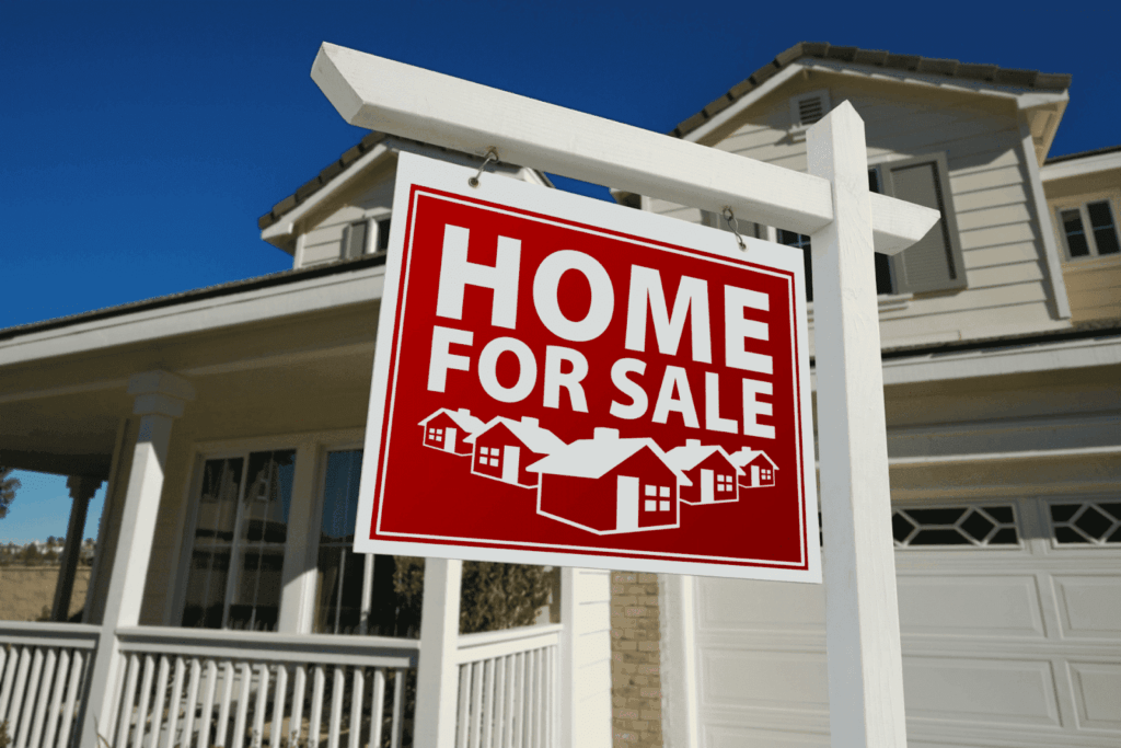 Red Home For Sale sign in front of a house.