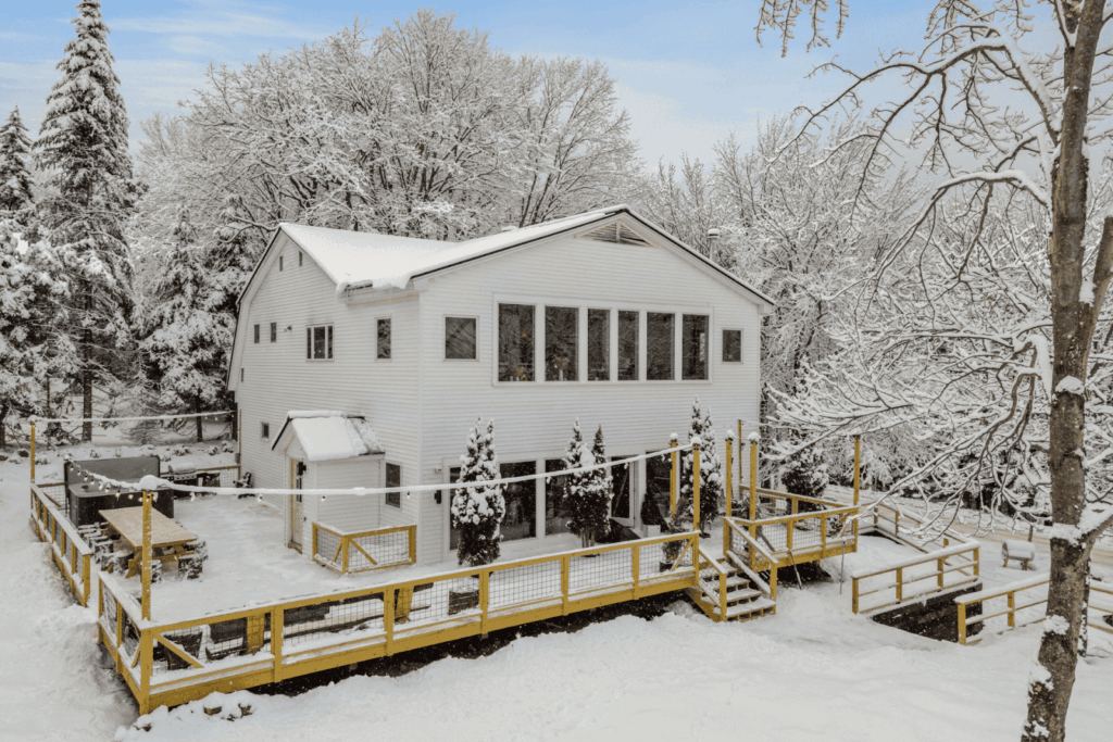 Beautiful white house surrounded by trees on a snowy winter day