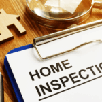 Home inspection clipboard with magnifying glass and house model.