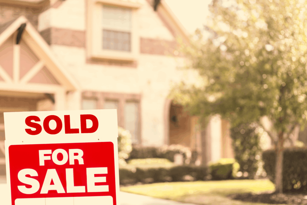 Home with a sold-for-sale sign in the front yard.