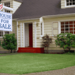 Sold house with for sale sign in front yard.