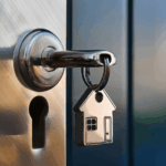House-shaped keychain hanging from a key inserted in a door lock.
