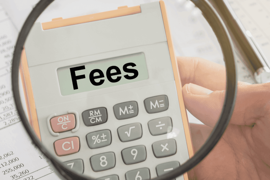 Calculator displaying the word fees under a magnifying glass