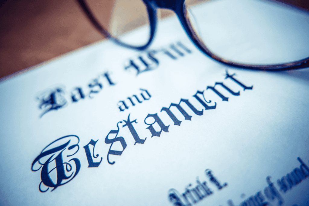 Close-up of a ‘Last Will and Testament’ document with eyeglasses resting on it
