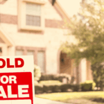 Home with sold for sale sign in the front yard.