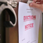 Close-up of eviction notice being posted on a front door during a legal eviction process in Arkansas.