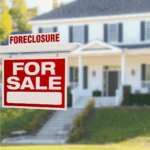 “Foreclosure” and “For Sale” sign in front of a house, indicating a foreclosed property on the market.