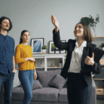 Real estate agent showing a home to a young couple.