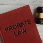 Red book titled “Probate Law” next to a judge’s gavel on a wooden table.