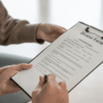 Person signing a divorce form on a clipboard