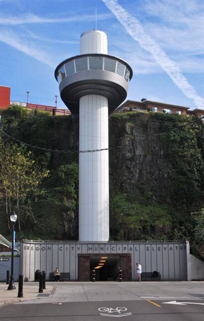 Portland Aerial Tram lower terminal with tower and hillside backdrop.
