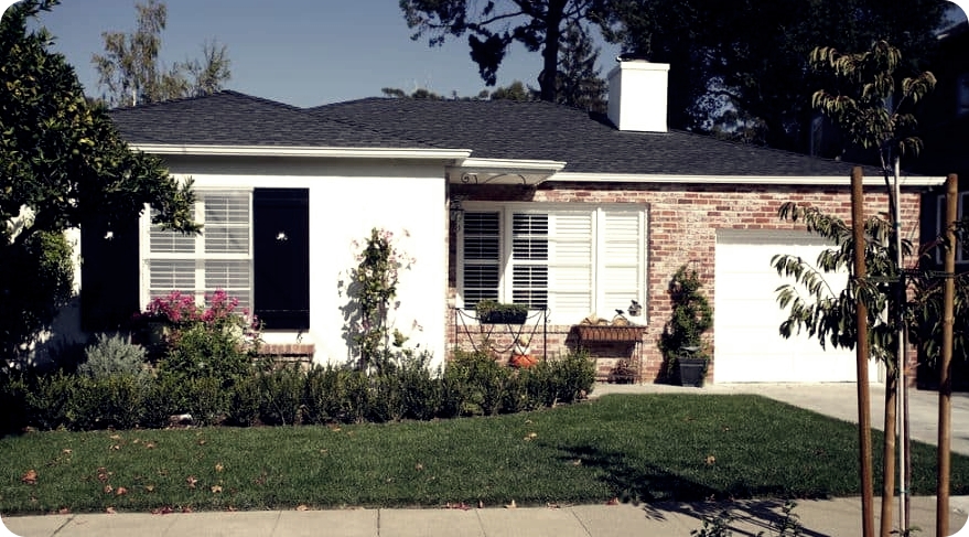 Small single family house with brick walls and white cement accents
