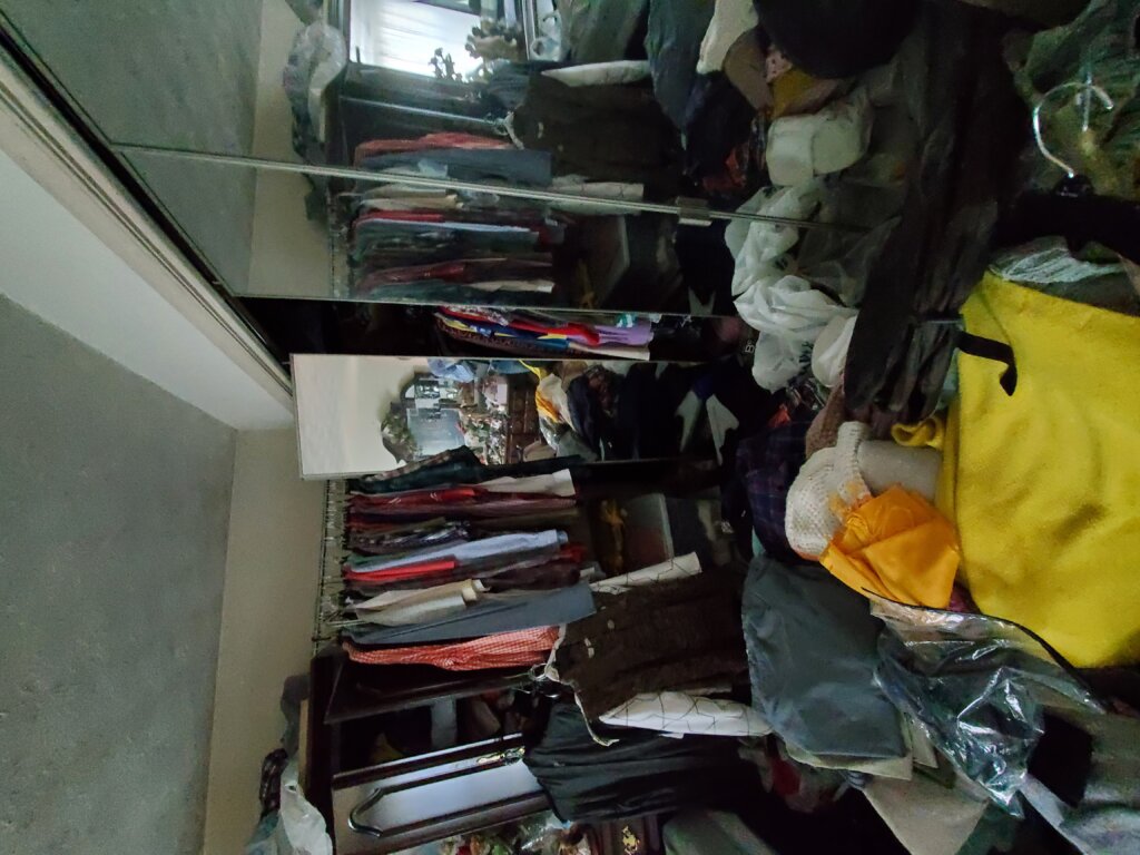 Messy room with clothes all over.