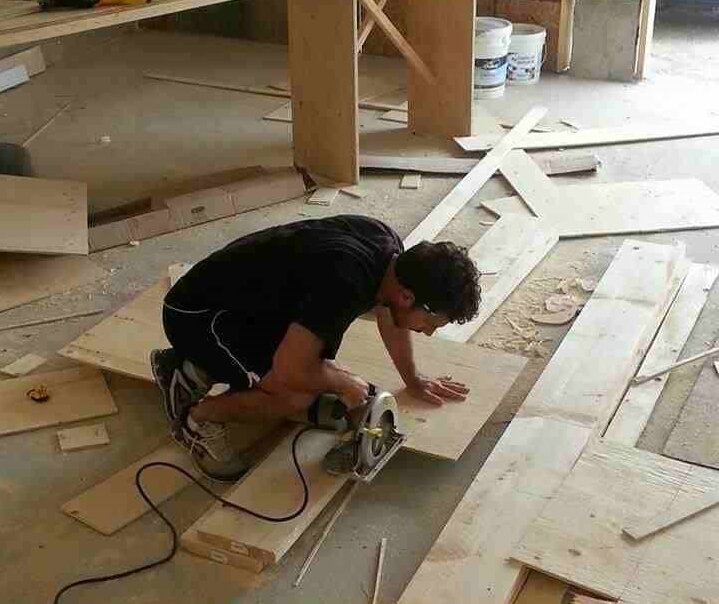 A contractor cutting a piece of wood