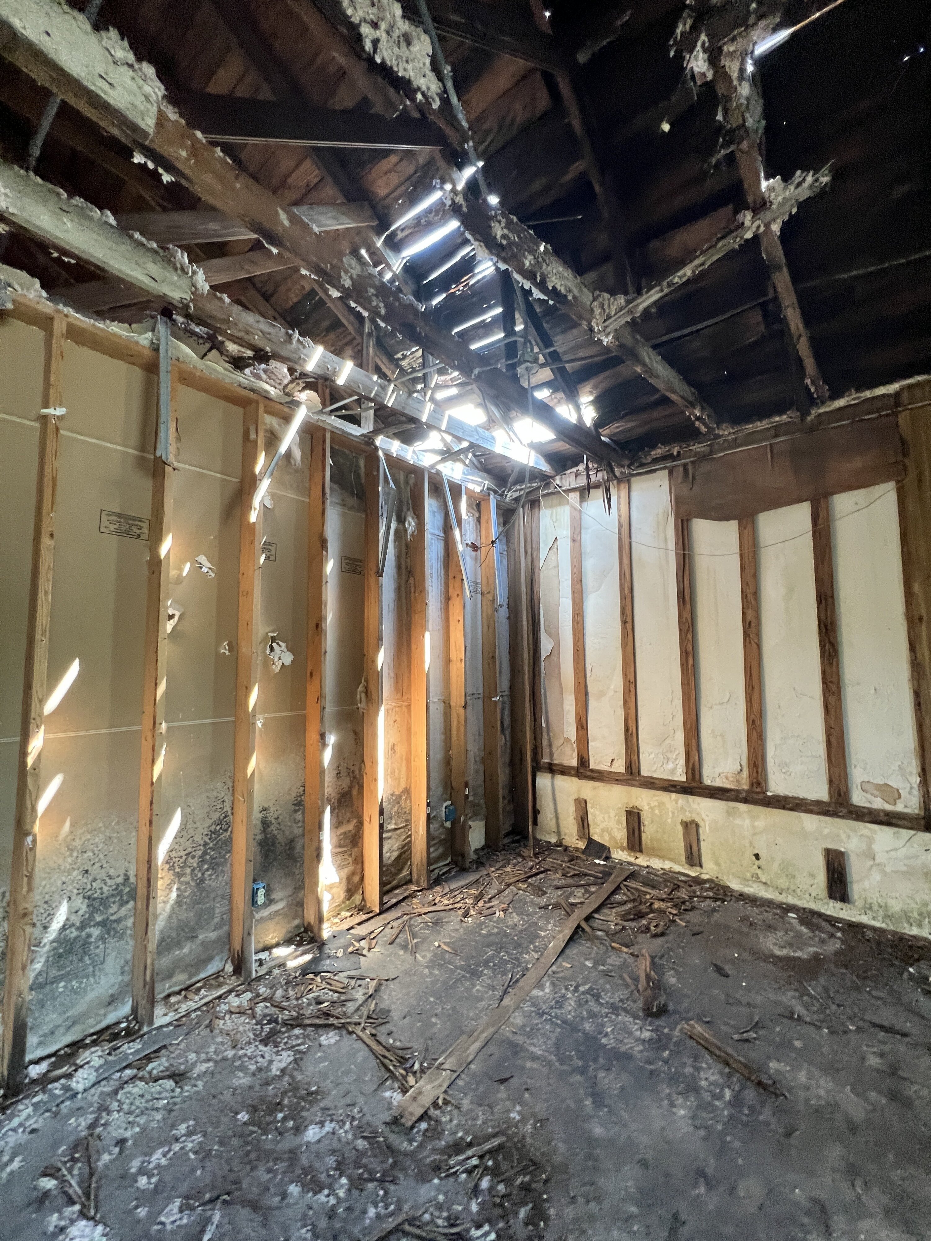 Damaged roof with light streaming into room; Milton, FL.