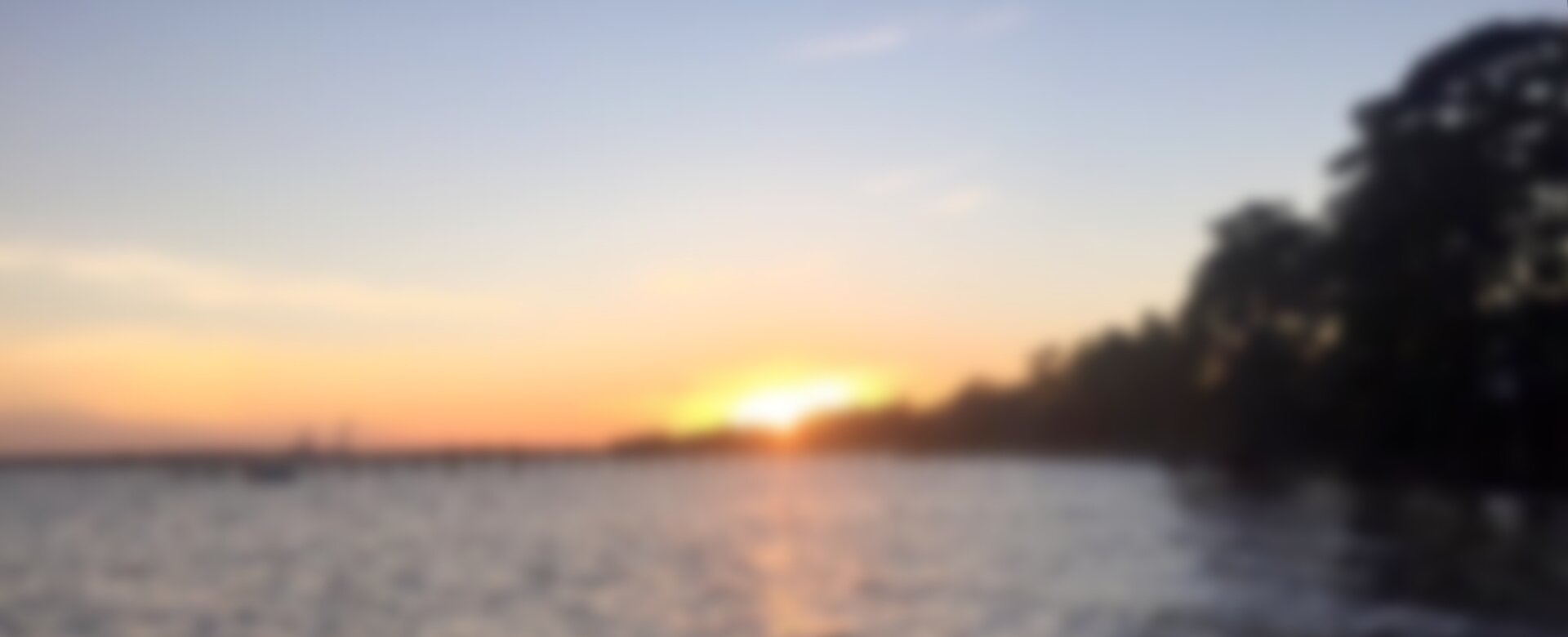 Image of sun setting over Pensacola Bay