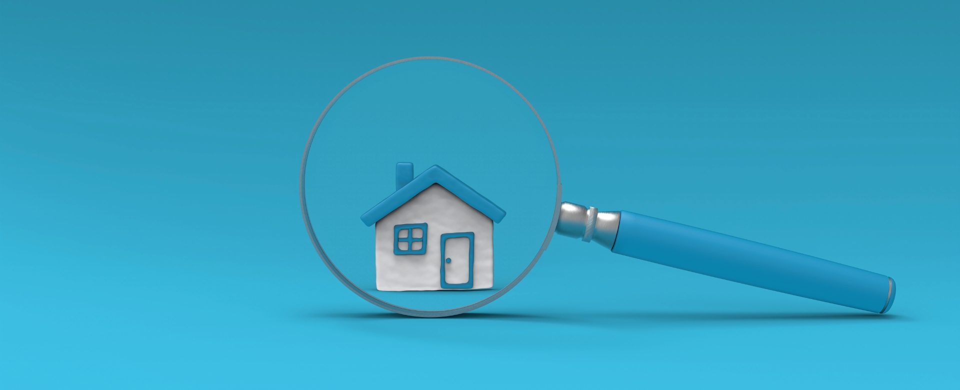 Model house under magnifying glass with blue background