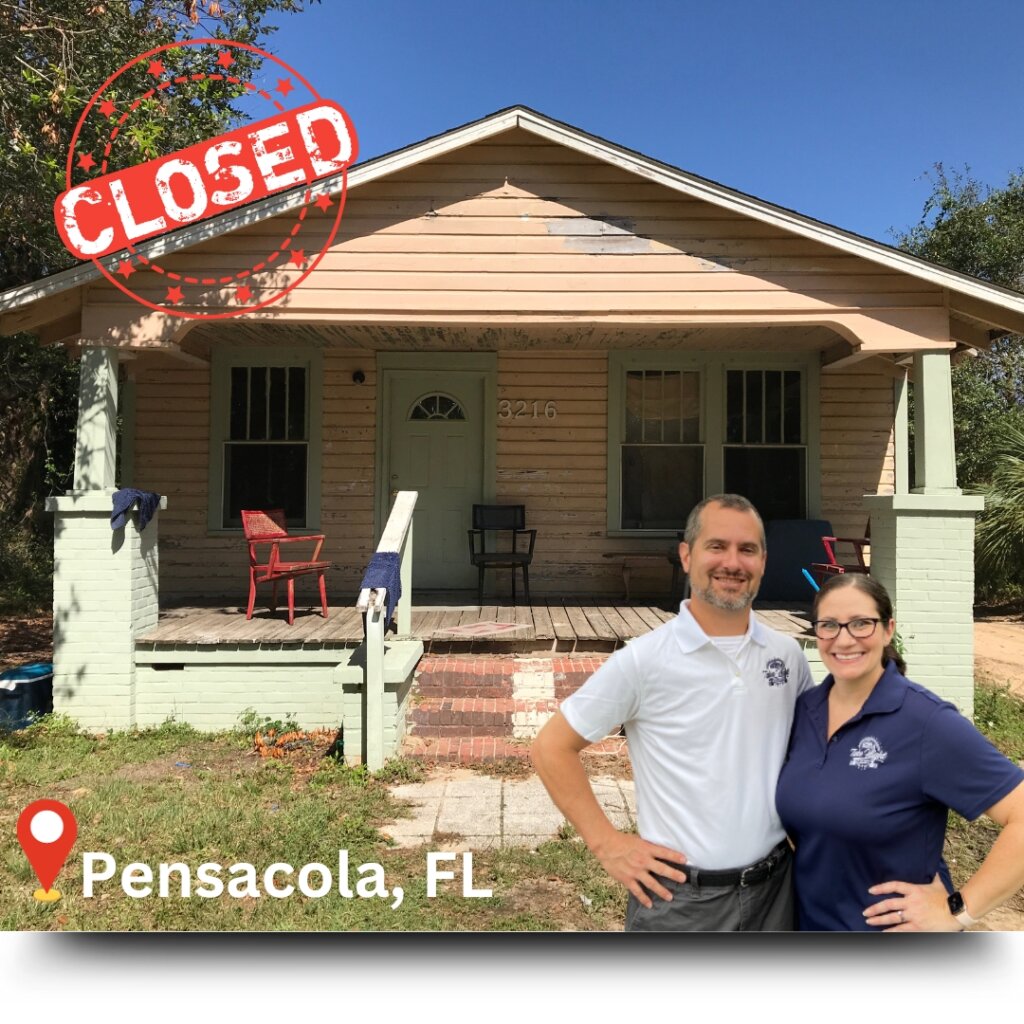 Anne & Mike in front of a house they purchased in Pensacola