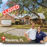 Anne & Mike in front of a Navarre house they purchased.