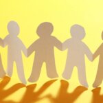 paper chain of people with yellow background