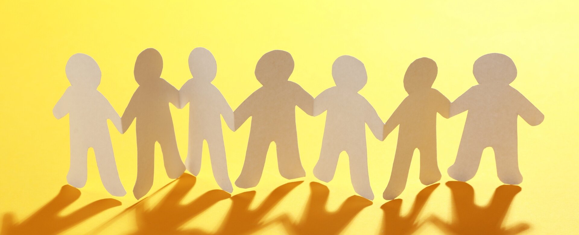paper chain of people with yellow background
