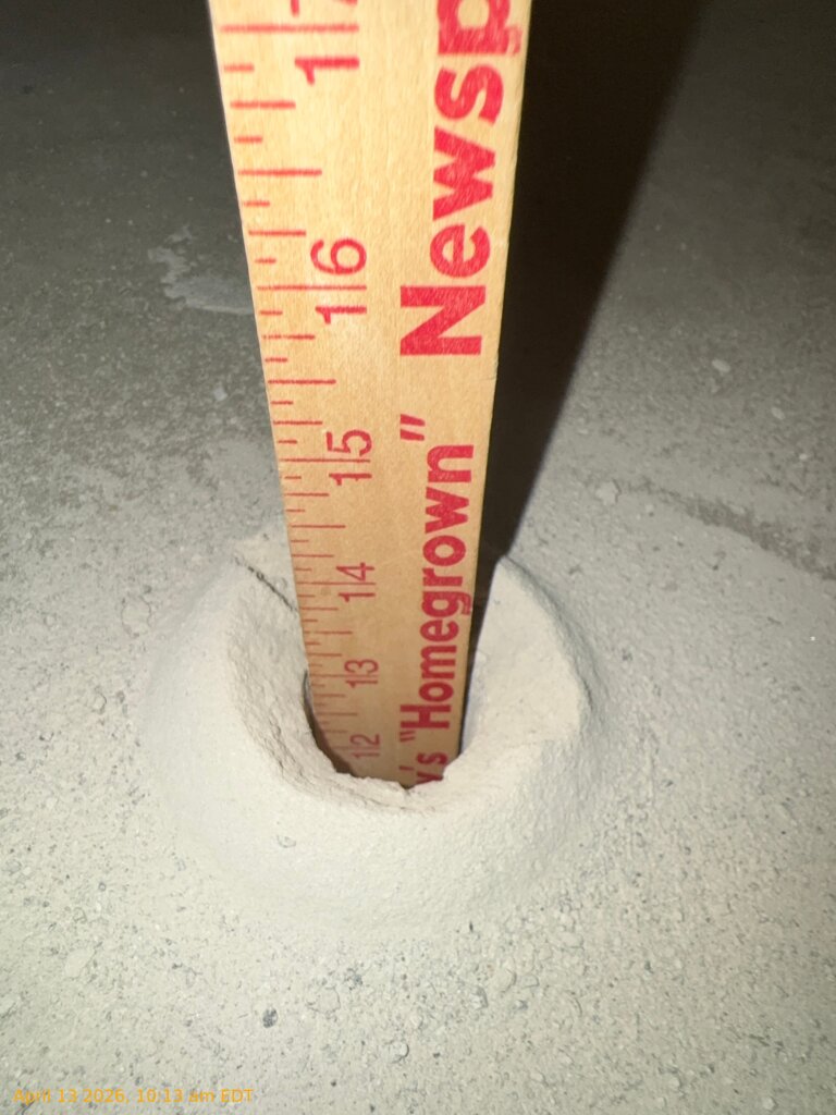 Inspection hole cut into concrete floor showing 16-inch void beneath slab in Medina Ohio home
