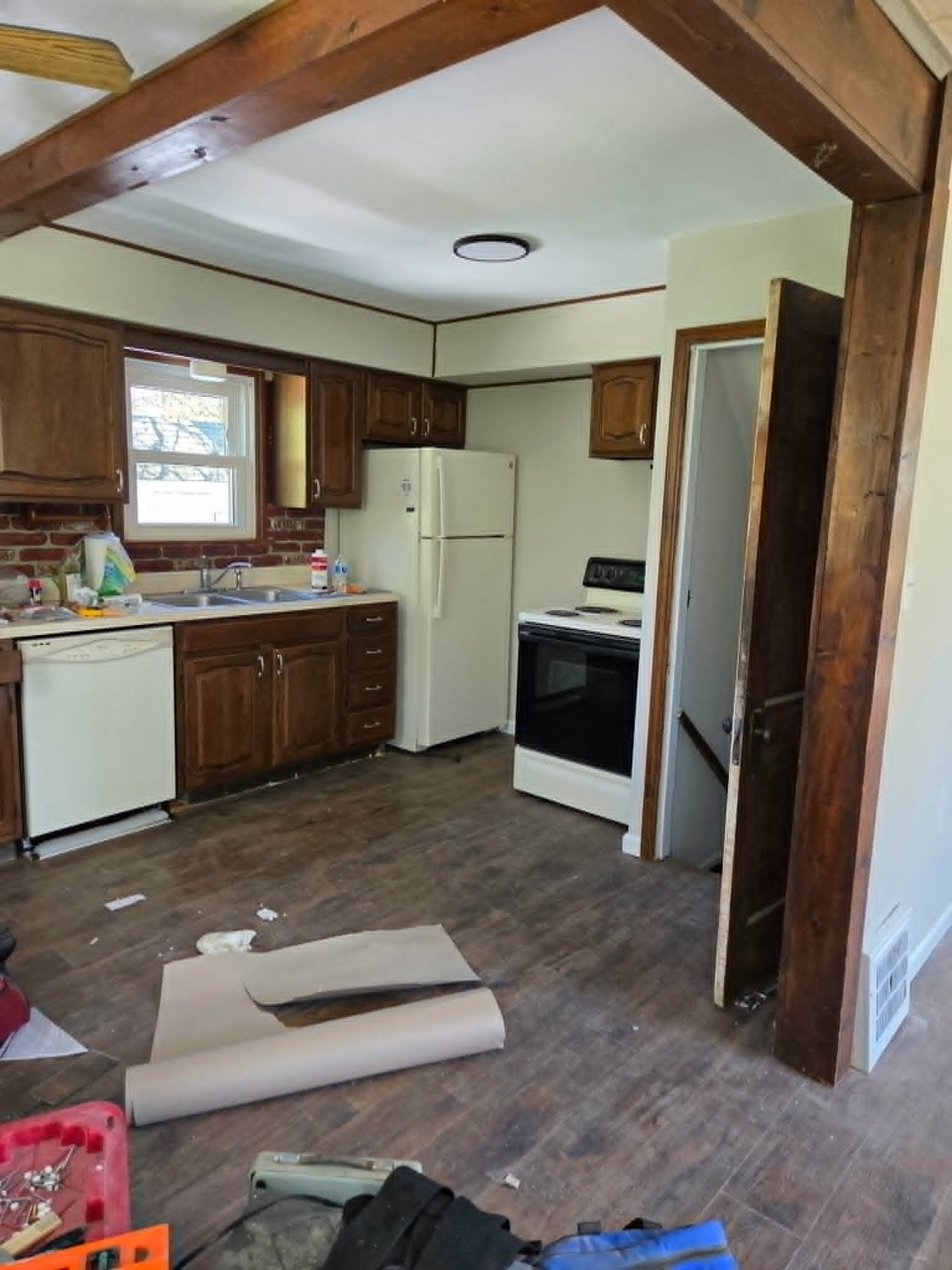 Kitchen and main living area during renovation work at an Oakwood Village house.