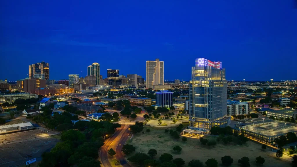 Fort Worth Texas skyline at night for local cash home buyers.