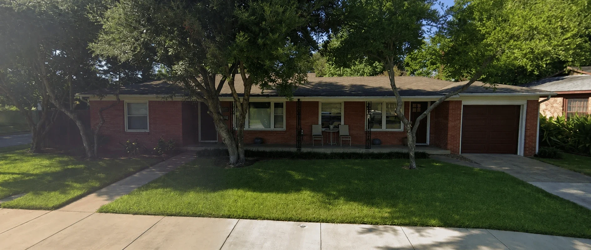 Front exterior of Oak Summit Group home office in Westworth Village, Texas with brick facade, front porch, and shaded lawn in a quiet residential neighborhood