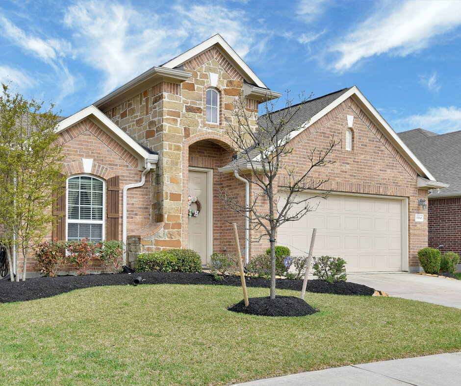 two-story tan brick house