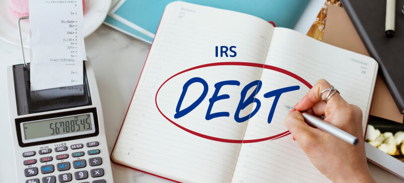 San Francisco homeowner reviewing IRS tax debt and home-sale documents before selling a property