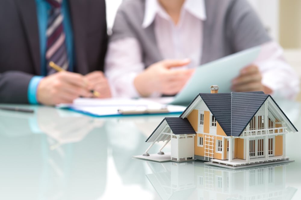 Family reviewing documents for the as-is sale of an inherited home in Concord, California