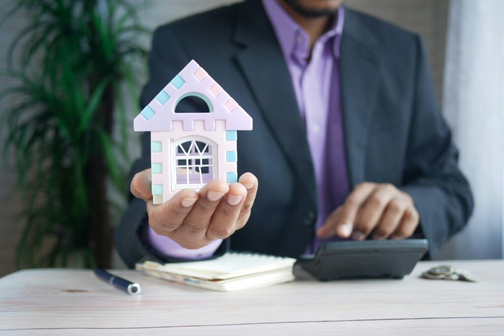 a man holding house in hand