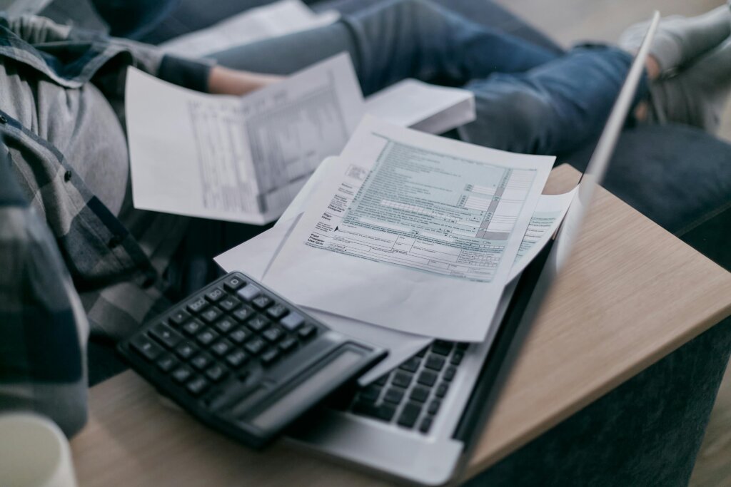 white paper with calculator and laptop