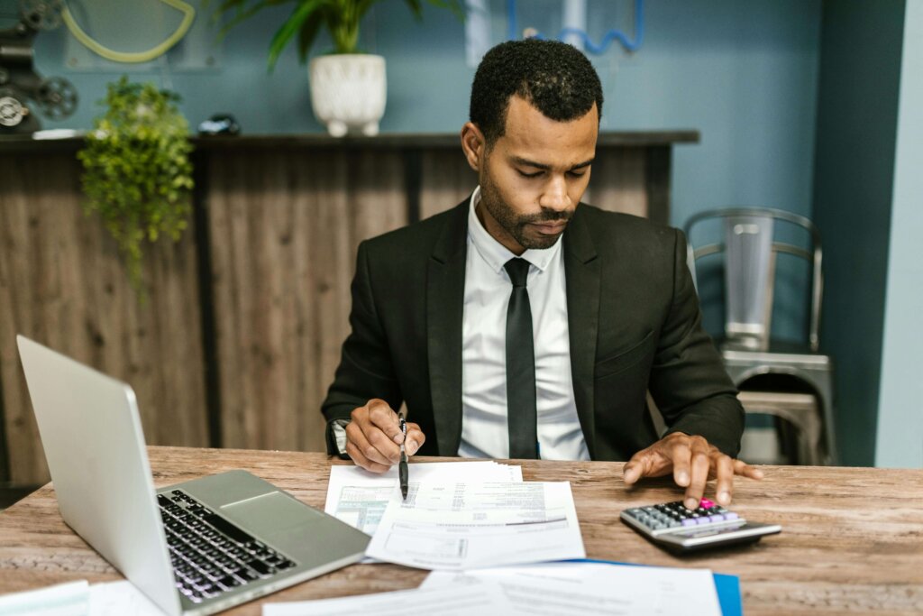 a man in black suit working