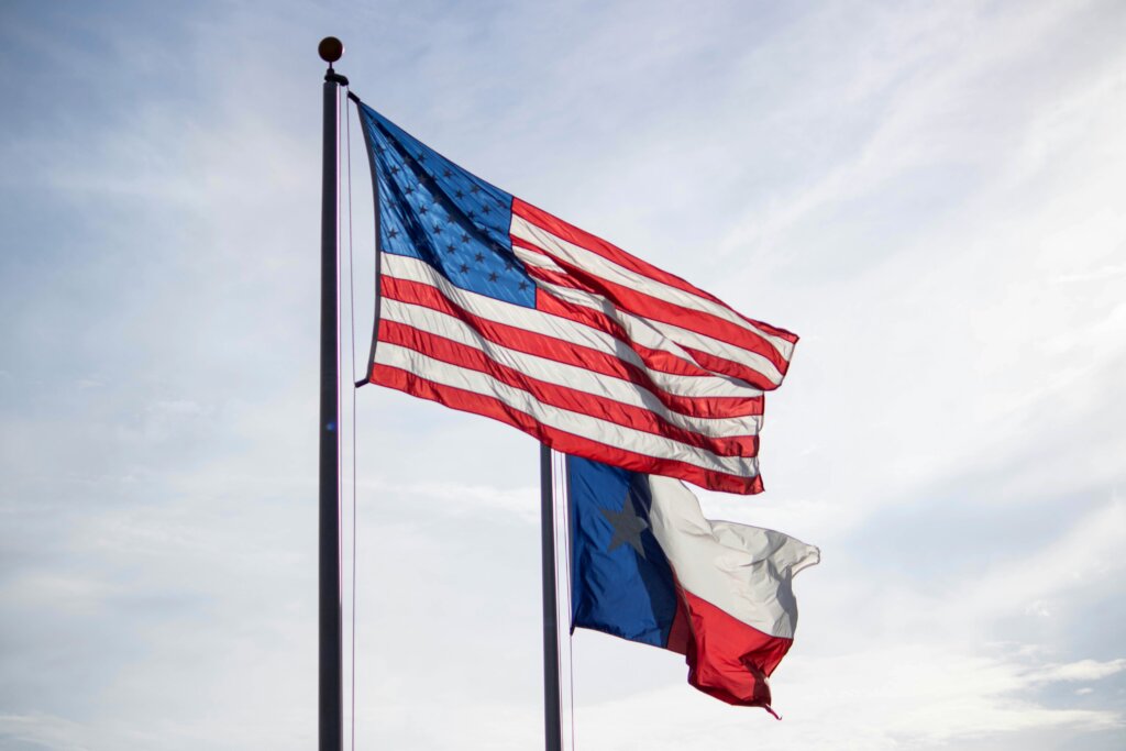 us and texas flags next to each other