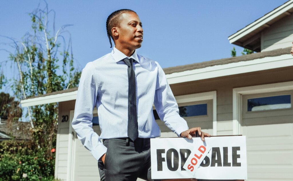 a real estate agent in front of the house