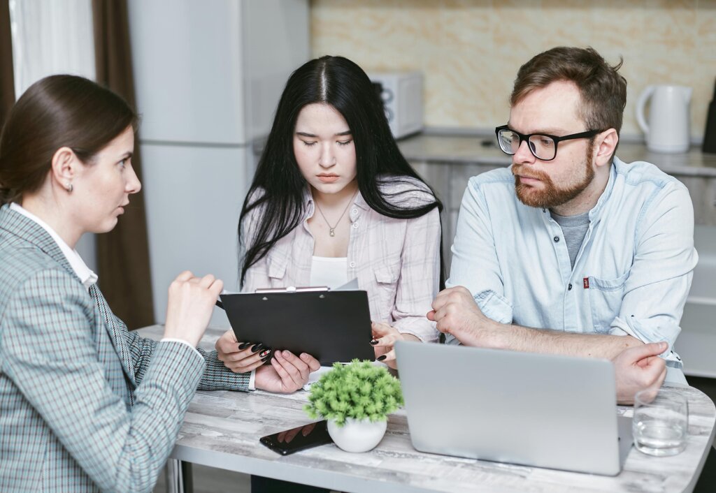 a couple listening to a real estate agent