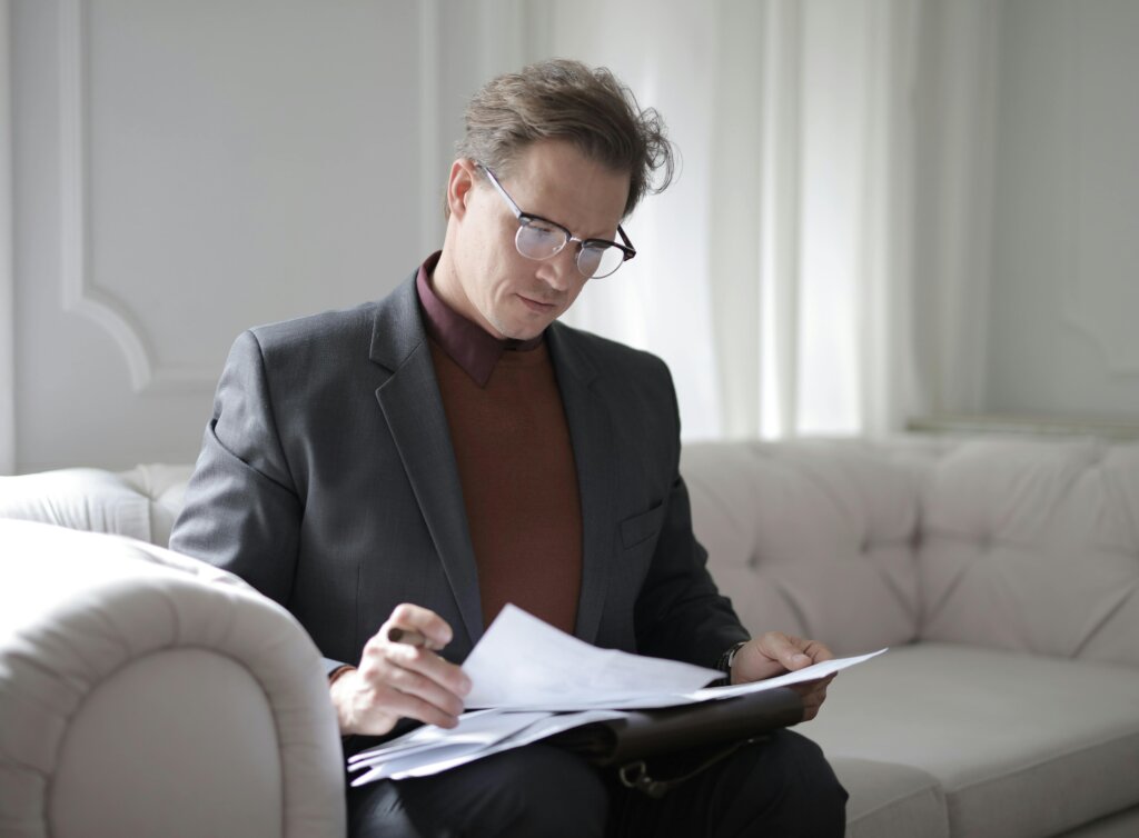 a man in suit reading documents
